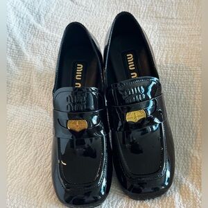 Miu Miu Shiny Black Loafers with Gold Detail